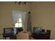 Living room with window, outdated televisions, chandelier, box and contents at 1050 E Highway 329, Citra, FL 32113