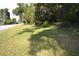 Wide shot of a grassy lot close to a road with mature trees at 1050 E Highway 329, Citra, FL 32113