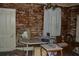 Unrenovated room featuring a chandelier, furniture, and peeling walls at 1050 E Highway 329, Citra, FL 32113