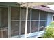 Enclosed porch with screens providing an outdoor living space with light and ventilation at 1050 E Highway 329, Citra, FL 32113
