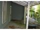 Open-air wrap around porch with views of a large yard and lush trees at 1050 E Highway 329, Citra, FL 32113