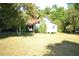 Expansive lawn and trees surround a single-story home with neutral-colored siding at 1050 E Highway 329, Citra, FL 32113
