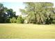 Expansive grassy yard, perfect for outdoor activities, with mature trees providing shade at 1050 E Highway 329, Citra, FL 32113