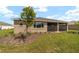 Well-maintained backyard with a screened lanai, green grass, and tasteful landscaping at 10562 Sw 96Th Lane Rd, Ocala, FL 34481