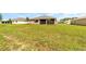 View of a spacious backyard showcasing green grass, perfect for outdoor activities at 10562 Sw 96Th Lane Rd, Ocala, FL 34481