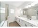 Modern bathroom features a double vanity, quartz counters, and a tiled glass shower at 10562 Sw 96Th Lane Rd, Ocala, FL 34481