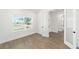 Bright bedroom features a large window with views, light walls and wood-look tile at 10562 Sw 96Th Lane Rd, Ocala, FL 34481