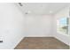 This bedroom has beautiful wood-look tile and a large window, allowing for plenty of natural light at 10562 Sw 96Th Lane Rd, Ocala, FL 34481