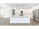 Modern kitchen featuring white cabinets, stainless steel appliances, and a granite island at 10562 Sw 96Th Lane Rd, Ocala, FL 34481
