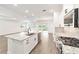 Kitchen view with granite island and stainless steel appliances, open to the living area at 10562 Sw 96Th Lane Rd, Ocala, FL 34481