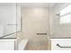 Tiled walk-in shower with glass surround, bench, and convenient grab bar at 10562 Sw 96Th Lane Rd, Ocala, FL 34481