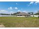 A sprawling backyard featuring a lush green lawn, mature trees, and a white vinyl fence at 10910 Sw 41St Ave, Ocala, FL 34476
