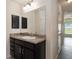 Bathroom featuring single sink vanity, granite countertops, medicine cabinet and a mirror at 10910 Sw 41St Ave, Ocala, FL 34476