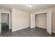 A bedroom featuring grey wood-look floors, a closet, and view to the next room at 10910 Sw 41St Ave, Ocala, FL 34476
