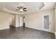 Spacious bedroom featuring wood-look tile flooring, a ceiling fan, and access to the outdoors at 10910 Sw 41St Ave, Ocala, FL 34476