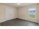 A bedroom featuring a double door closet, a window and grey wood-look floors at 10910 Sw 41St Ave, Ocala, FL 34476
