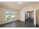 Bedroom featuring wood-look tile flooring, a vaulted ceiling, and ample natural light from the large window at 10910 Sw 41St Ave, Ocala, FL 34476