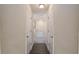 Hallway leading to a bathroom with double doors and tub, showcasing the home's layout at 10910 Sw 41St Ave, Ocala, FL 34476