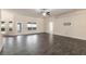 Open-concept living room featuring tile floors, a ceiling fan, and natural light at 10910 Sw 41St Ave, Ocala, FL 34476