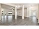 Open-concept living room featuring wood-look tile flooring, ample space, and natural light streaming in from the windows at 10910 Sw 41St Ave, Ocala, FL 34476