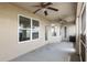 A covered patio featuring two ceiling fans, and multiple windows with a view of the backyard at 10910 Sw 41St Ave, Ocala, FL 34476