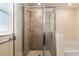 Close up of a shower with glass doors, showcasing modern tile and fixtures at 10910 Sw 41St Ave, Ocala, FL 34476