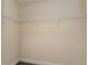 This is a walk-in closet, featuring white wire shelving and grey wood-look floors at 10910 Sw 41St Ave, Ocala, FL 34476