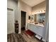 Well-lit bathroom features double sinks, wood-style floors and a separate room with a toilet at 11412 Sw 51St Cir, Ocala, FL 34476