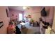 Playful bedroom with pink walls, carpet, window light and creative storage solutions at 11412 Sw 51St Cir, Ocala, FL 34476