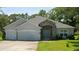 Charming single-story home with a well-manicured lawn and a welcoming stone entryway at 11412 Sw 51St Cir, Ocala, FL 34476