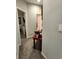 Hallway featuring neutral decor, carpet, and an accent table with decor at 11412 Sw 51St Cir, Ocala, FL 34476