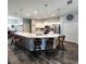 Bright kitchen featuring an extended breakfast bar, stainless appliances, and modern pendant lighting at 11412 Sw 51St Cir, Ocala, FL 34476