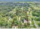 Beautiful aerial view of property featuring mature trees and acreage, surrounded by neighboring homes and lush greenery at 12677 Se 53Rd Terrace Rd, Belleview, FL 34420