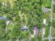Aerial view of the house and neighborhood surrounded by lush trees at 12677 Se 53Rd Terrace Rd, Belleview, FL 34420