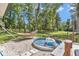 Landscaped backyard featuring mature trees, a hammock, and a unique stock tank pool at 12677 Se 53Rd Terrace Rd, Belleview, FL 34420