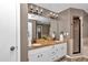 Bathroom with double sinks, granite countertops, and a framed mirror at 12677 Se 53Rd Terrace Rd, Belleview, FL 34420