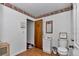 Bathroom with wood door and Coca-Cola wallpaper at 12677 Se 53Rd Terrace Rd, Belleview, FL 34420