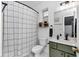 Well-lit bathroom with decorative shower curtain, accent-colored vanity, and modern fixtures at 12677 Se 53Rd Terrace Rd, Belleview, FL 34420