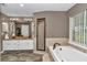 A spacious bathroom features a soaking tub, a separate shower, and double vanity sinks at 12677 Se 53Rd Terrace Rd, Belleview, FL 34420