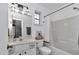 Bright bathroom featuring a shower-tub combo with a curtain, vanity, and toilet at 12677 Se 53Rd Terrace Rd, Belleview, FL 34420