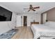 Large bedroom with hardwood floors, a ceiling fan, and ample natural light at 12677 Se 53Rd Terrace Rd, Belleview, FL 34420