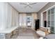 Neutral-toned bedroom with bright light from the large glass doors, light curtains, and tiled floors at 12677 Se 53Rd Terrace Rd, Belleview, FL 34420