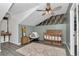 Charming Bedroom with wainscoting, crib, decor, ceiling fan and gray wood floors at 12677 Se 53Rd Terrace Rd, Belleview, FL 34420