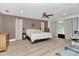 Spacious bedroom with a ceiling fan, wood flooring, and neutral decor at 12677 Se 53Rd Terrace Rd, Belleview, FL 34420