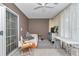 Bedroom featuring neutral tones, tile floors, large sliding glass doors, and a ceiling fan at 12677 Se 53Rd Terrace Rd, Belleview, FL 34420