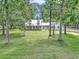 Beautiful home nestled among mature trees, with a well-manicured lawn at 12677 Se 53Rd Terrace Rd, Belleview, FL 34420