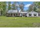 Charming single-story home featuring manicured lawn and metal roof at 12677 Se 53Rd Terrace Rd, Belleview, FL 34420