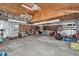 Unfinished garage with tools, work bench, and shelving, offering ample storage and project space at 12677 Se 53Rd Terrace Rd, Belleview, FL 34420
