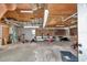 Large, unfinished garage space with exposed ceiling, a workbench, and tools for various projects at 12677 Se 53Rd Terrace Rd, Belleview, FL 34420