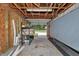 Unfinished garage featuring shelving and open garage door at the end at 12677 Se 53Rd Terrace Rd, Belleview, FL 34420